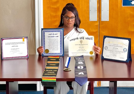 student displaying their certificates and achievements before graduation